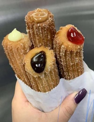 Handheld order of assorted filled churros